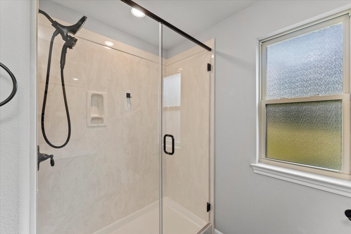 17855 Arbor Oaks Circle New Caney, TX 77357 - Photo 24 of 26 a bathroom that has a glass shower door