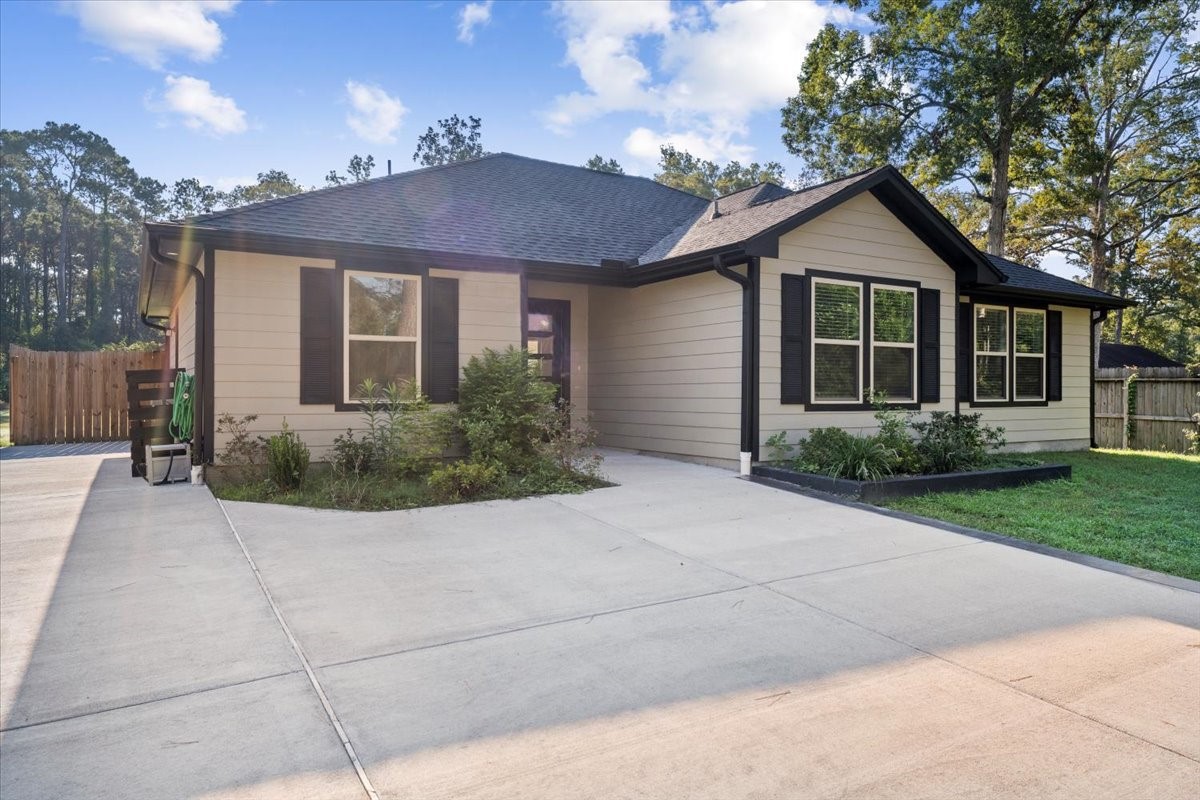 17855 Arbor Oaks Circle New Caney, TX 77357 - Photo 4 of 26 a view of house with outdoor space and a yard