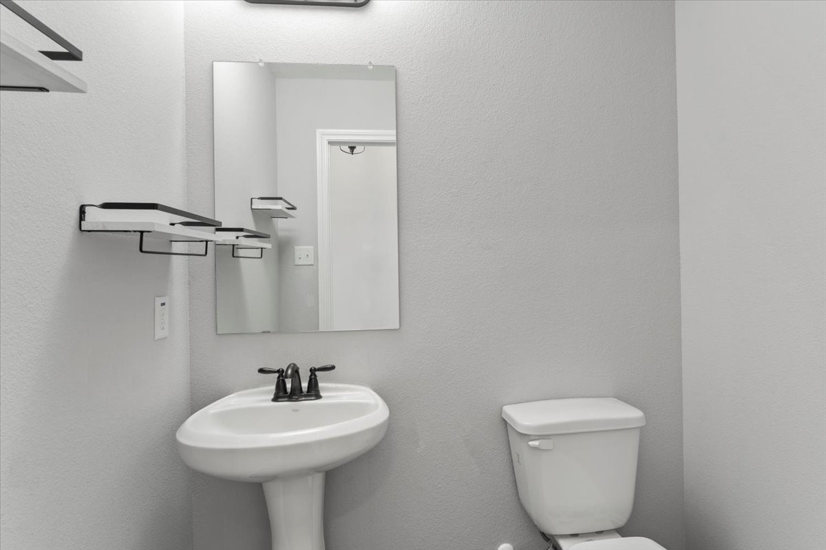 17855 Arbor Oaks Circle New Caney, TX 77357 - Photo 8 of 26 a bathroom with a toilet sink and mirror