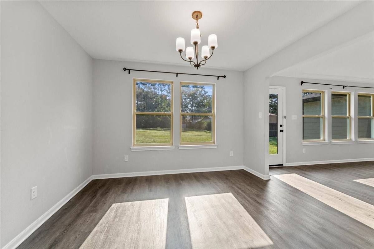 17855 Arbor Oaks Circle New Caney, TX 77357 - Photo 9 of 26 wooden floor in an empty room with a window