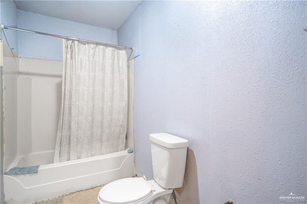 3905 Los Ebanos Road Mission, TX 78573 - Photo 11 of 20 a white toilet sitting next to a bath tub