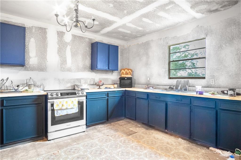 3905 Los Ebanos Road Mission, TX 78573 - Photo 2 of 20 a kitchen with a sink cabinets and window