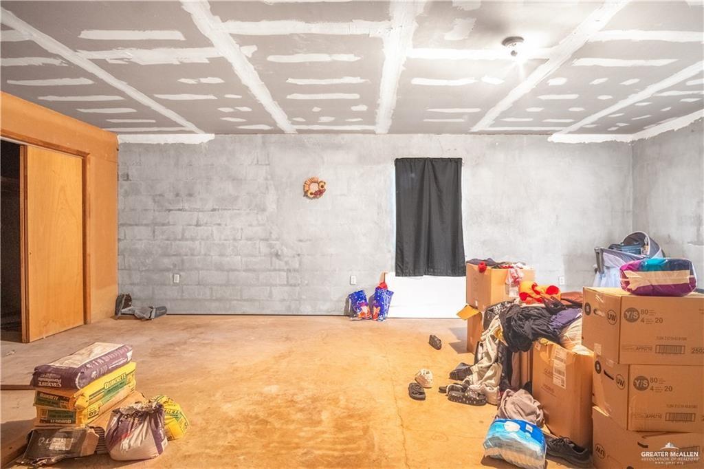 3905 Los Ebanos Road Mission, TX 78573 - Photo 9 of 20 a bed room with a bed and a chandelier