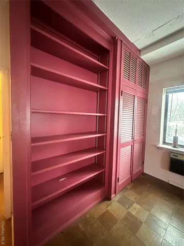 a bathroom with a granite countertop toilet sink and mirror