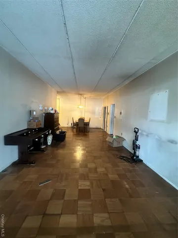 a room with gym equipment and a view of living room