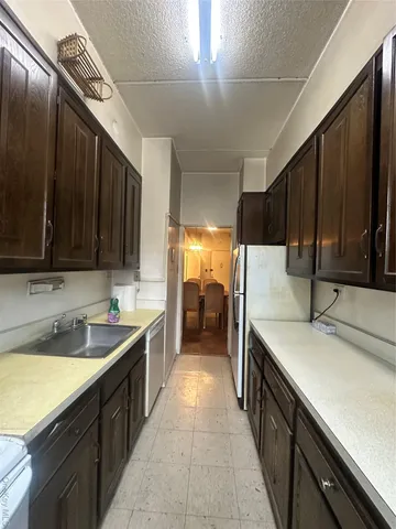 a kitchen with a sink and large cabinets
