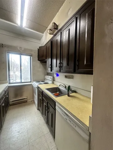 a kitchen with a sink stove top oven and cabinets