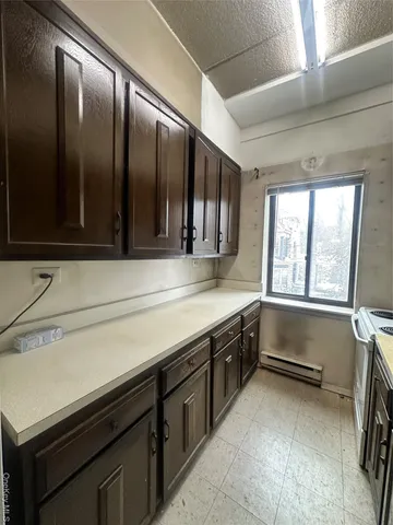 a view of a hallway with stainless steel appliances