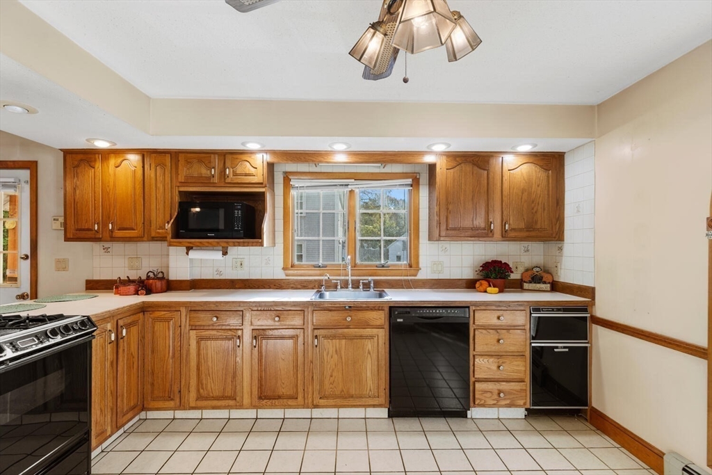 33 Springdale Avenue Saugus, MA 01906 - Photo 12 of 37 a kitchen with a sink stove and cabinets