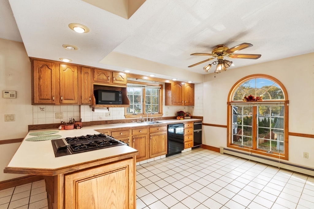 33 Springdale Avenue Saugus, MA 01906 - Photo 13 of 37 a kitchen with a stove a sink and a microwave