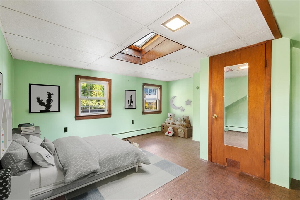 33 Springdale Avenue Saugus, MA 01906 - Photo 25 of 37 a bedroom with a bed and a gym equipment