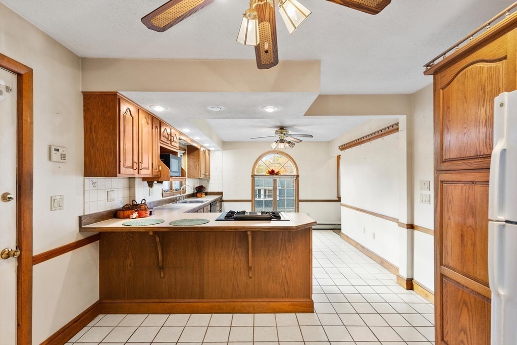 33 Springdale Avenue Saugus, MA 01906 - Photo 6 of 37 a kitchen with stainless steel appliances granite countertop a sink and a refrigerator