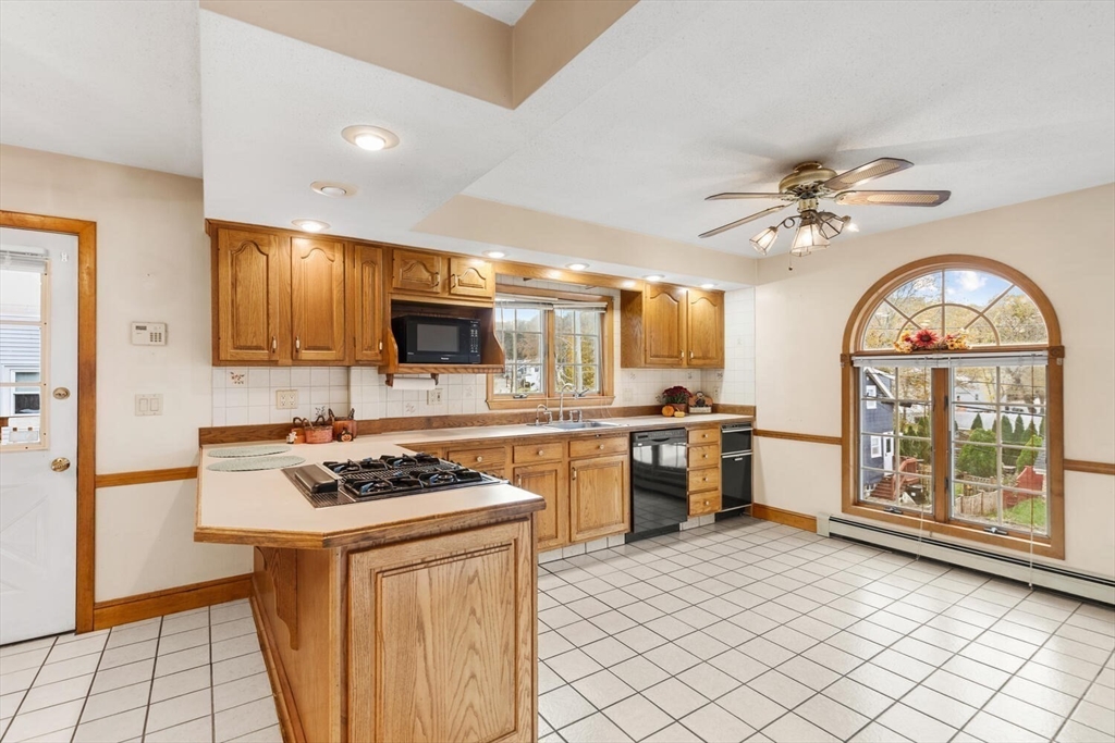 33 Springdale Avenue Saugus, MA 01906 - Photo 7 of 37 a kitchen with stainless steel appliances granite countertop a stove a sink dishwasher and a refrigerator with wooden floor