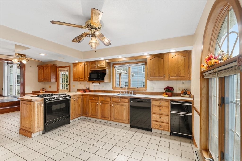 33 Springdale Avenue Saugus, MA 01906 - Photo 9 of 37 a kitchen with stainless steel appliances granite countertop a stove top oven a sink dishwasher and a refrigerator