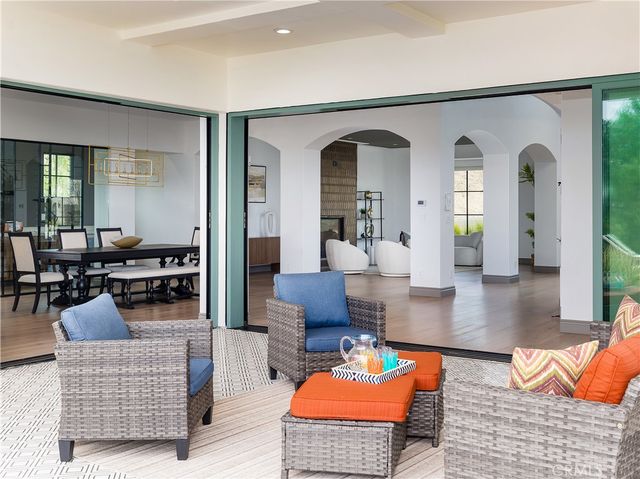 a living room with furniture a rug and a view of kitchen