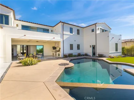 a view of a patio with swimming pool table and chairs