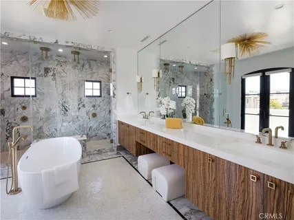 a spacious bathroom with a double vanity sink a mirror a bathtub and a shower