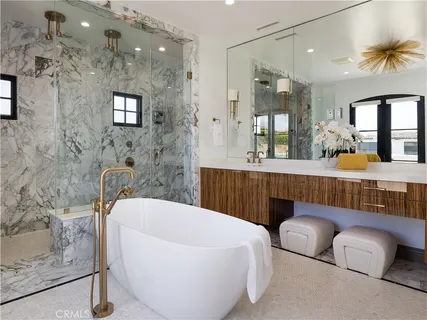 a bathroom with a tub a sink and a mirror