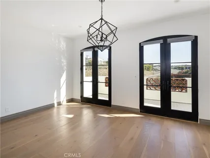 a view of an empty room with glass door and a window