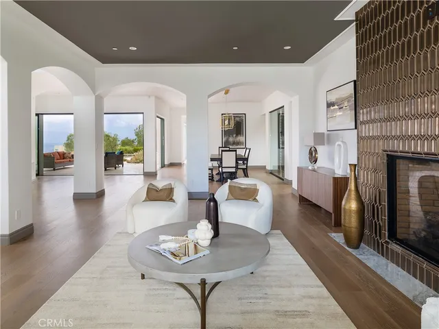 a living room with fireplace furniture and a wooden floor