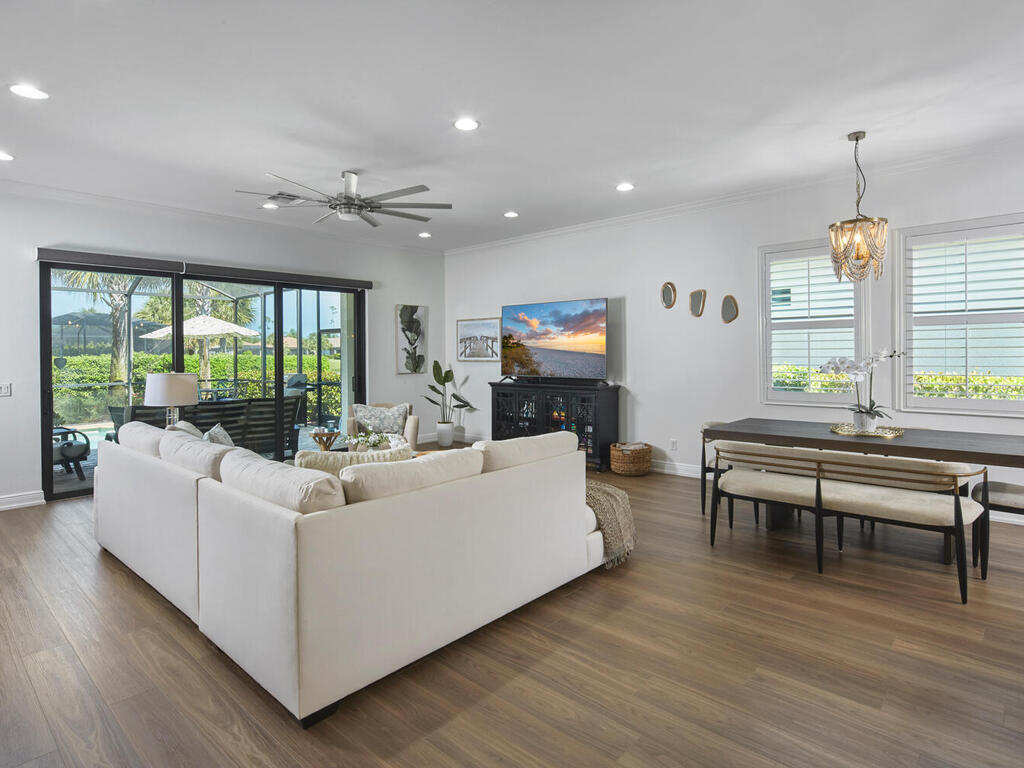 4613 Abaca Circle Naples, FL 34119 - Photo 13 of 36 a living room with furniture a large window and a flat screen tv