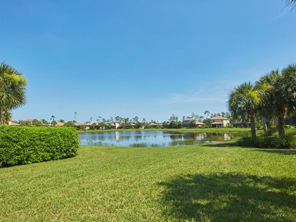 4613 Abaca Circle Naples, FL 34119 - Photo 6 of 36 a view of a lake with houses in the back
