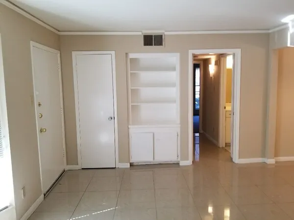 an empty room with closet and a bathroom