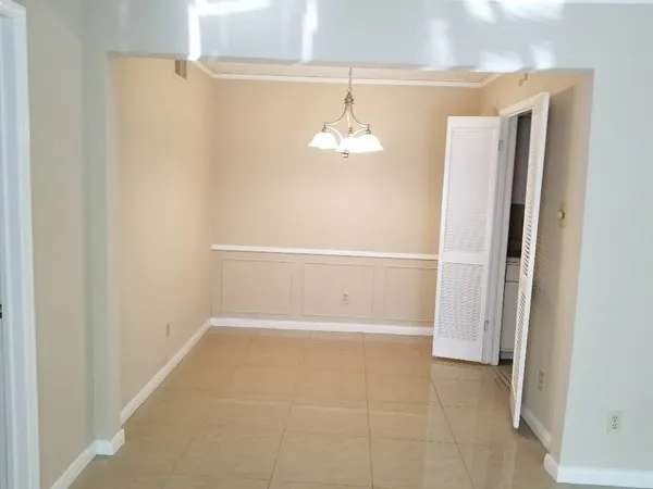 a view of empty room with ceiling fan