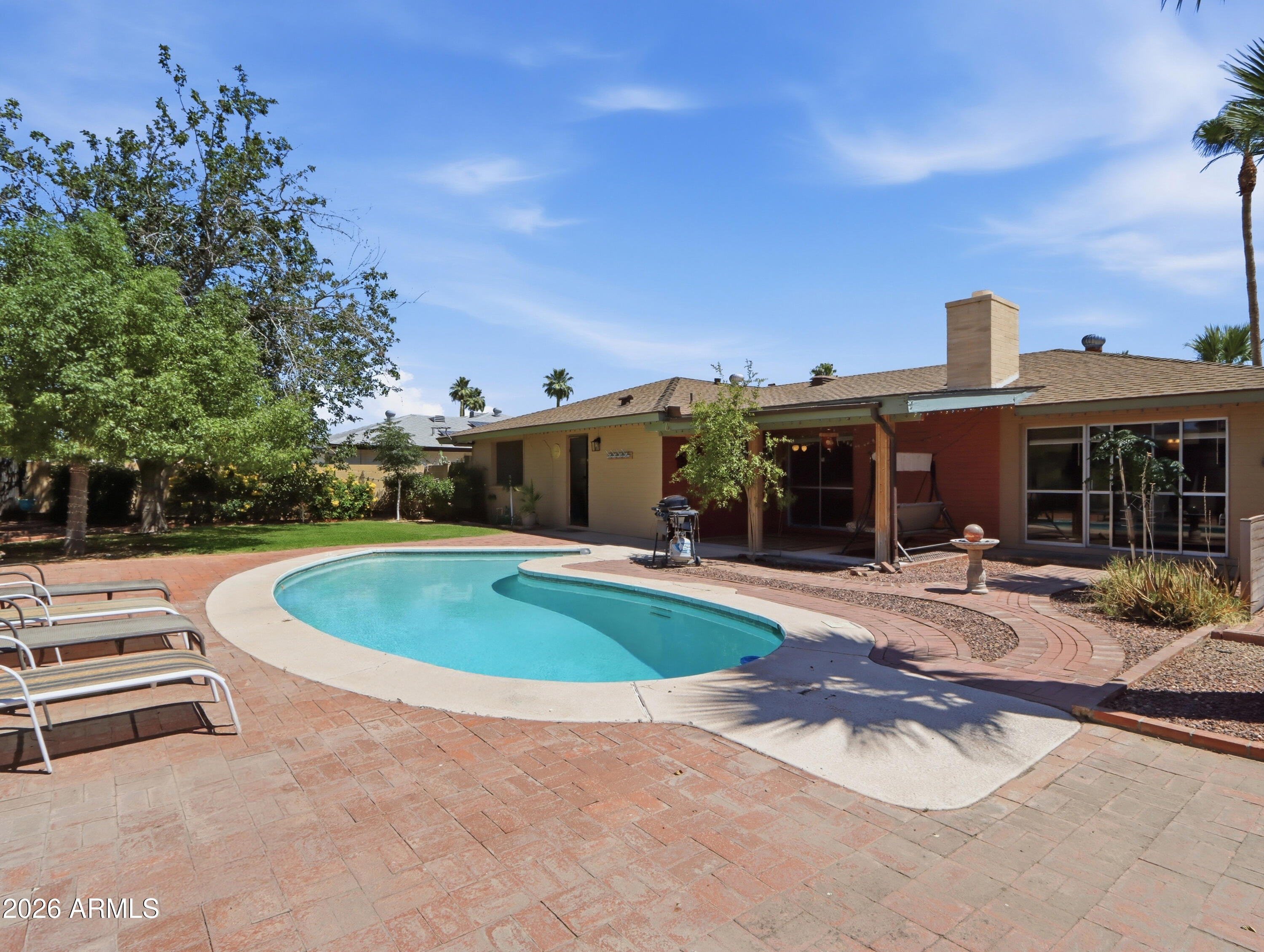 450 Cascada Road Litchfield Park, AZ 85340 - Photo 28 of 40 a view of a house with swimming pool and sitting area