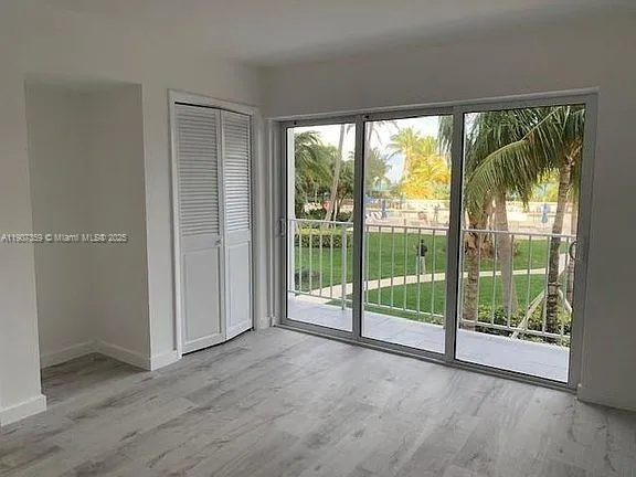 a view of a room with large windows and pool table