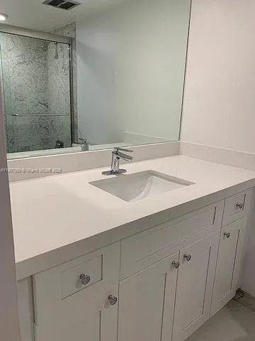 a bathroom with a sink and a mirror