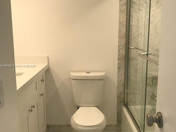 881 Ocean Drive, Unit TH11 Key Biscayne, FL 33149 - Photo 14 of 22 a white toilet sitting next to a bathroom sink