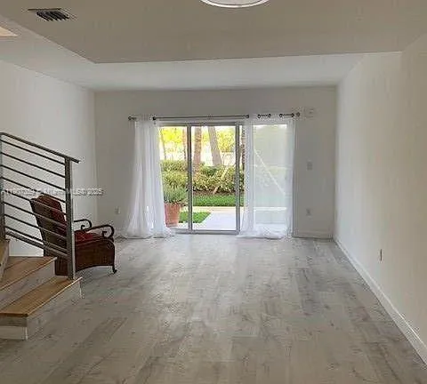 an empty room with furniture and windows