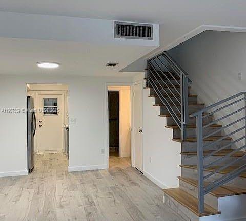 881 Ocean Drive, Unit TH11 Key Biscayne, FL 33149 - Photo 3 of 22 a view of entryway and gallery with wooden floor