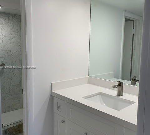 881 Ocean Drive, Unit TH11 Key Biscayne, FL 33149 - Photo 8 of 22 a bathroom with a sink and a mirror
