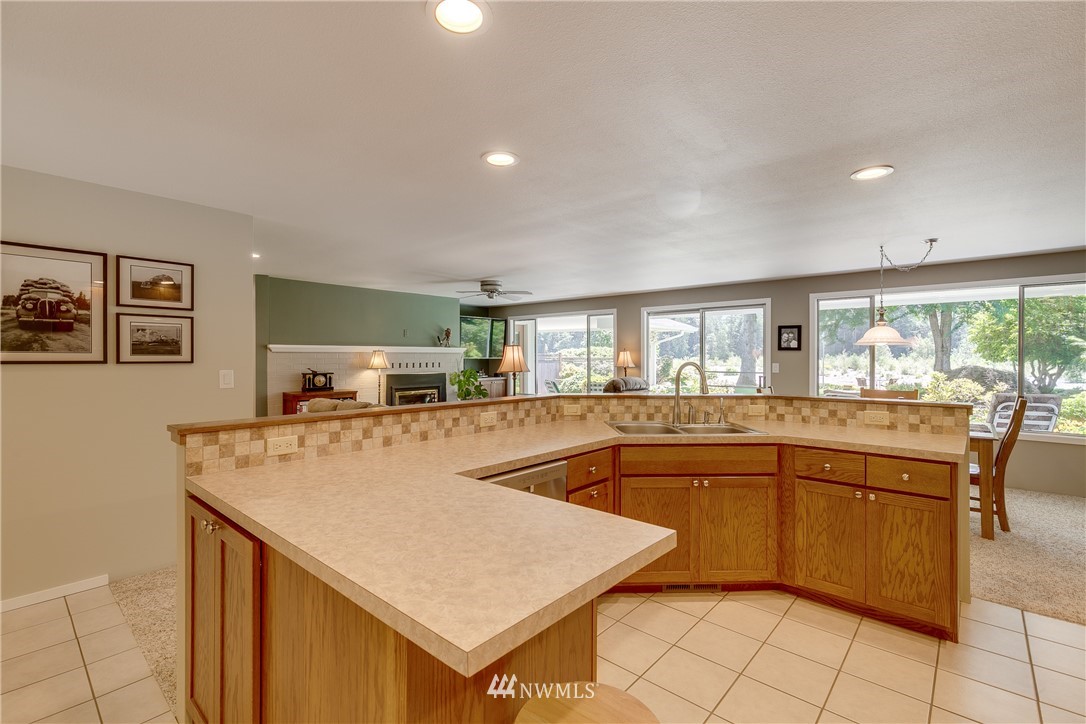 1118 Dyer Road Sultan, WA 98294 - Photo 14 of 40 a kitchen with stainless steel appliances granite countertop a sink and white cabinets