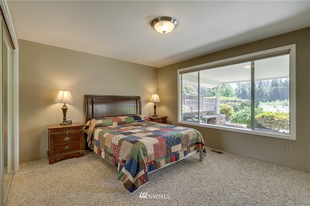1118 Dyer Road Sultan, WA 98294 - Photo 20 of 40 a bedroom with a bed lamp and window