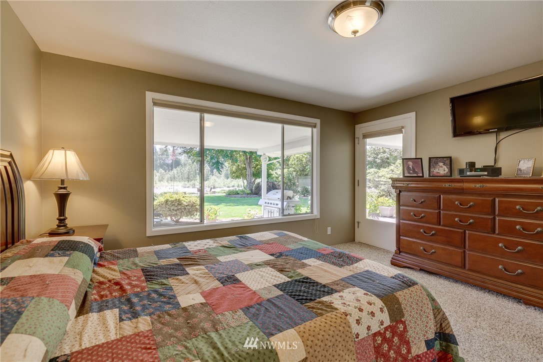 1118 Dyer Road Sultan, WA 98294 - Photo 22 of 40 a bedroom with a bed and large windows