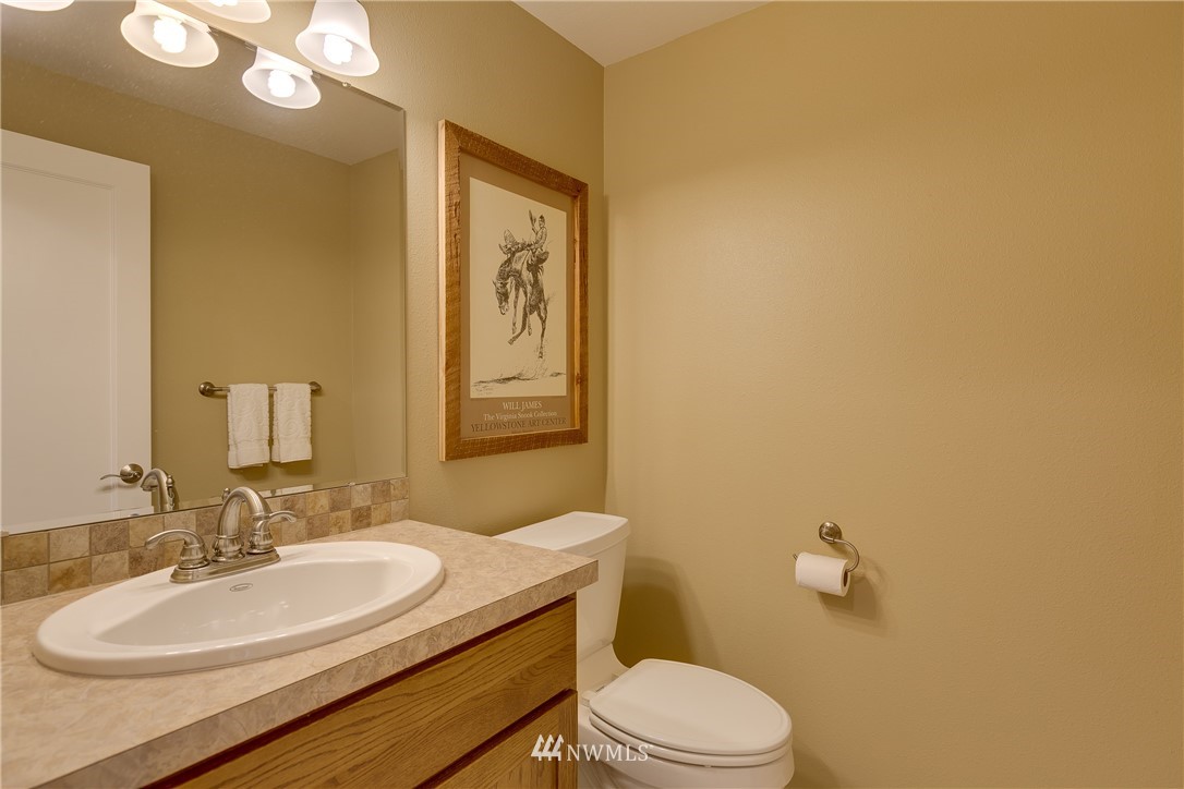 1118 Dyer Road Sultan, WA 98294 - Photo 7 of 40 a bathroom with a granite countertop sink mirror vanity and toilet
