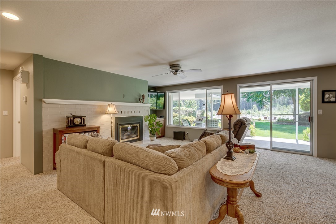 1118 Dyer Road Sultan, WA 98294 - Photo 8 of 40 a living room with furniture a fireplace and a large window