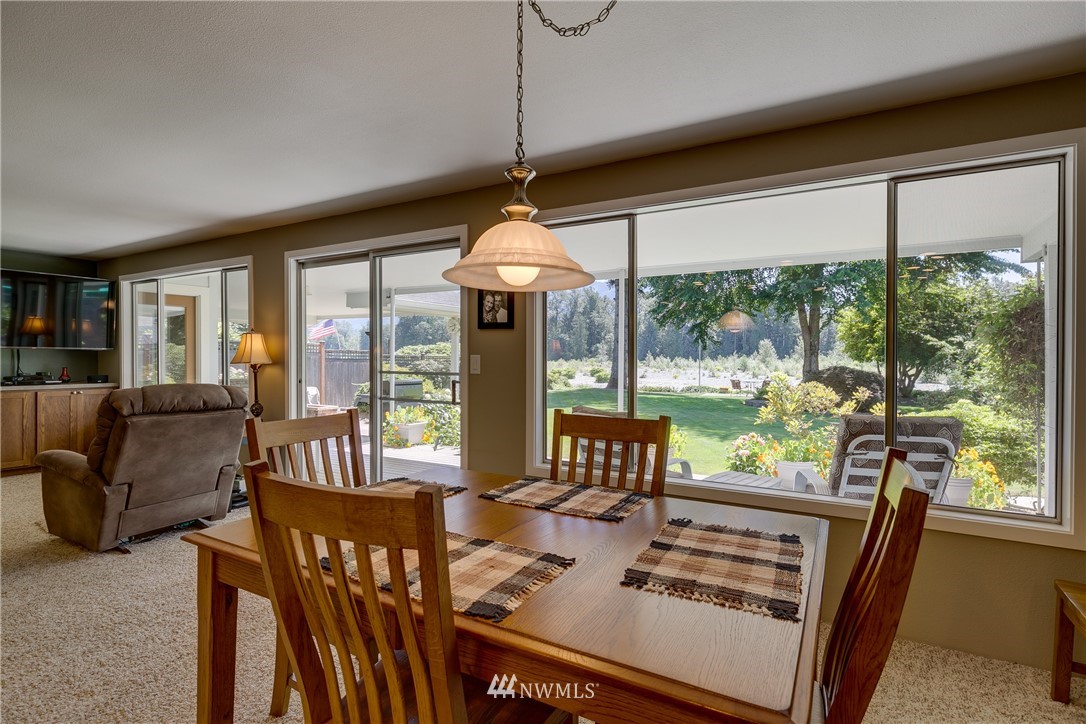 1118 Dyer Road Sultan, WA 98294 - Photo 10 of 40 a dining room with furniture a chandelier and wooden floor