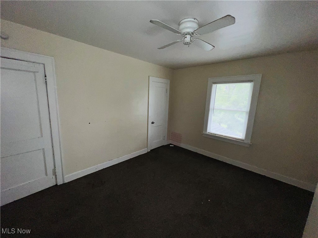 968 Whitby Road Cleveland Heights, OH 44112 - Photo 10 of 19 Unfurnished bedroom with dark carpet and ceiling fan