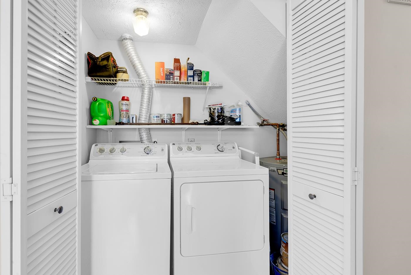 830 44th Avenue North, Unit L1 Myrtle Beach, SC 29577 - Photo 21 of 40 Laundry area featuring a textured ceiling, water heater, and separate washer and dryer