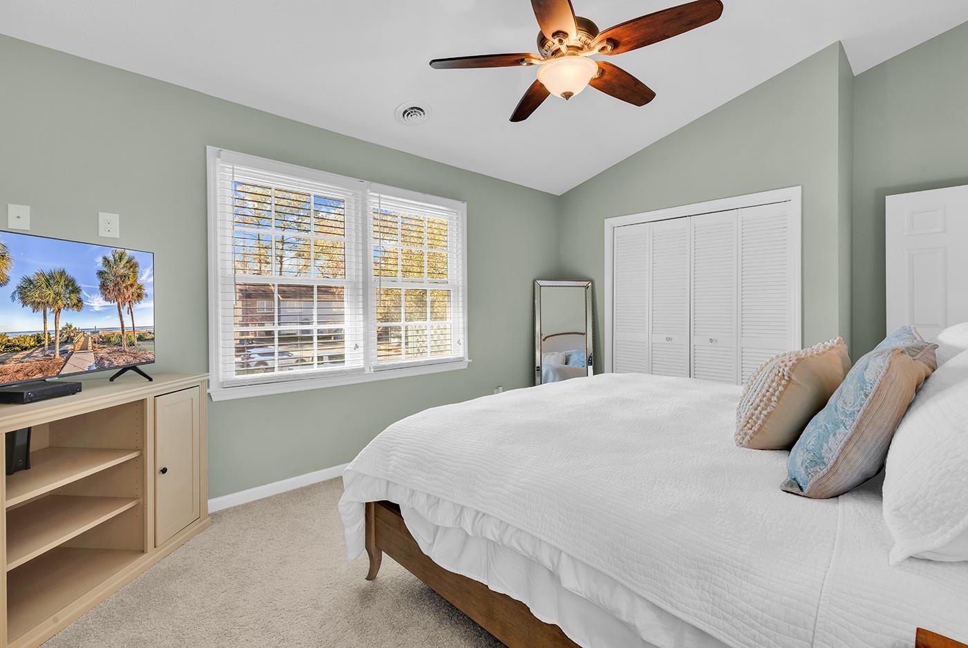 830 44th Avenue North, Unit L1 Myrtle Beach, SC 29577 - Photo 27 of 40 Bedroom featuring vaulted ceiling, a closet, light colored carpet, and a ceiling fan