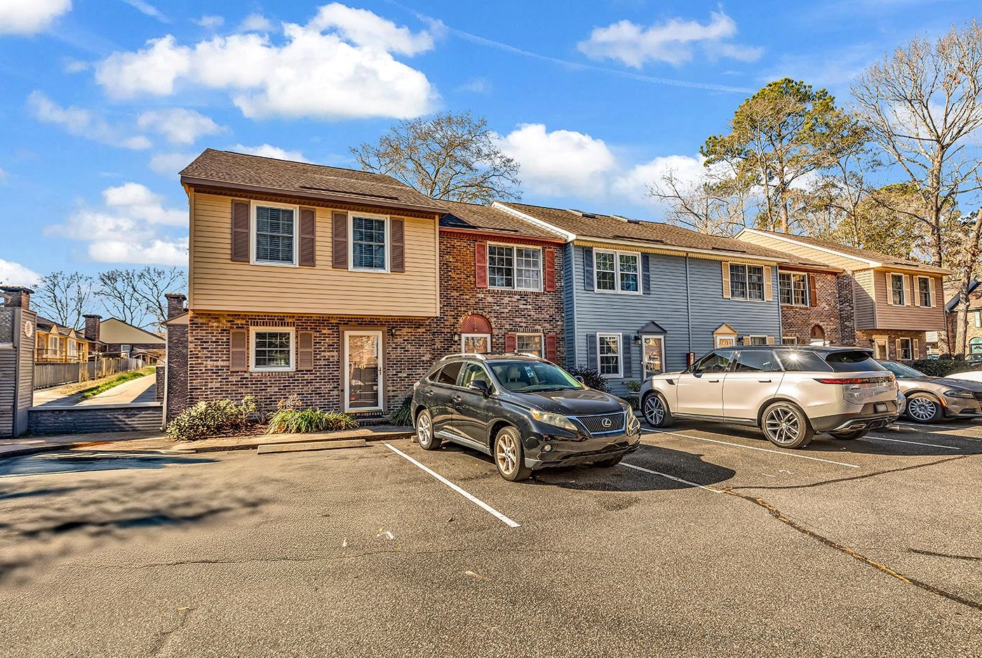 830 44th Avenue North, Unit L1 Myrtle Beach, SC 29577 - Photo 3 of 40 View of front of home featuring brick siding, uncovered parking, and a residential view