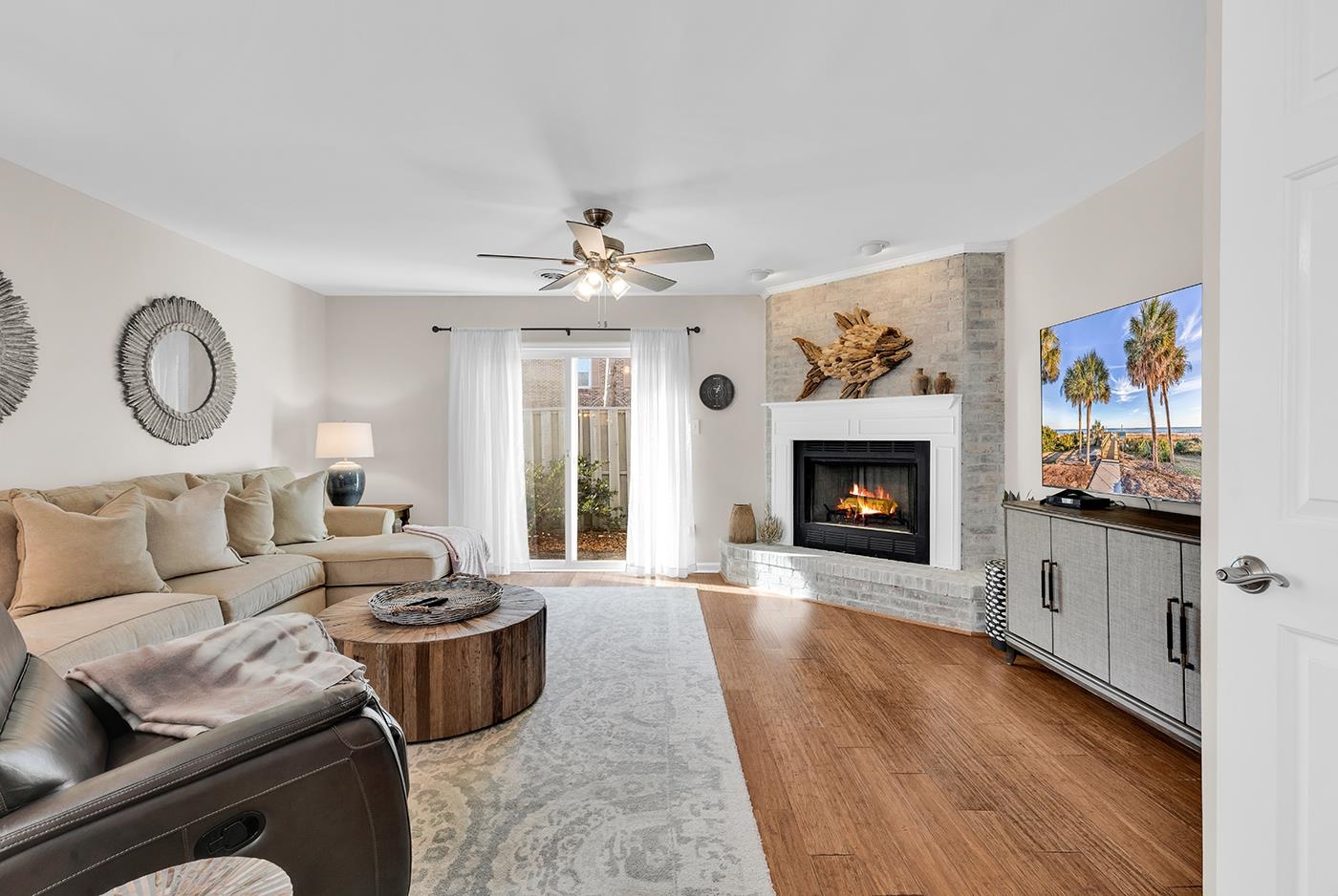 830 44th Avenue North, Unit L1 Myrtle Beach, SC 29577 - Photo 5 of 40 Living area with a fireplace, wood finished floors, and a ceiling fan