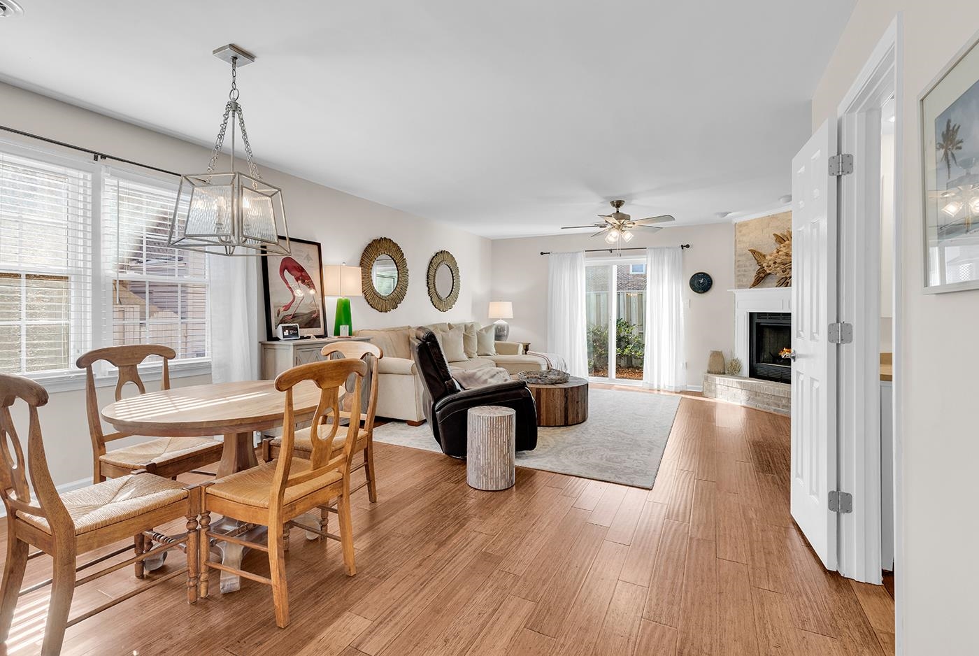830 44th Avenue North, Unit L1 Myrtle Beach, SC 29577 - Photo 10 of 40 Dining room with light wood-style floors, a fireplace, ceiling fan, and a chandelier