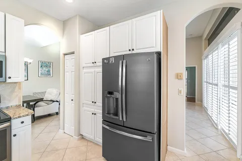 a view of a kitchen with refrigerator and cabinet