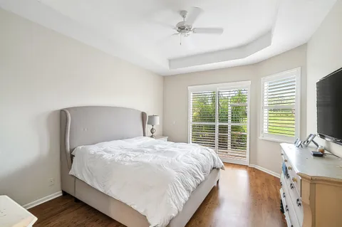 a bedroom with a bed and a flat tv screen on dresser