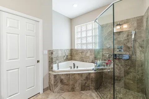 a bathroom with a bathtub and shower